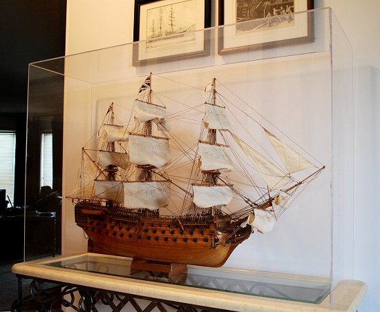 HMS Victory    model under a large acrylic cap with clear beveled edges.