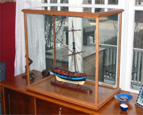 Cherry display case with a wood and glass top displaying an 18th ...